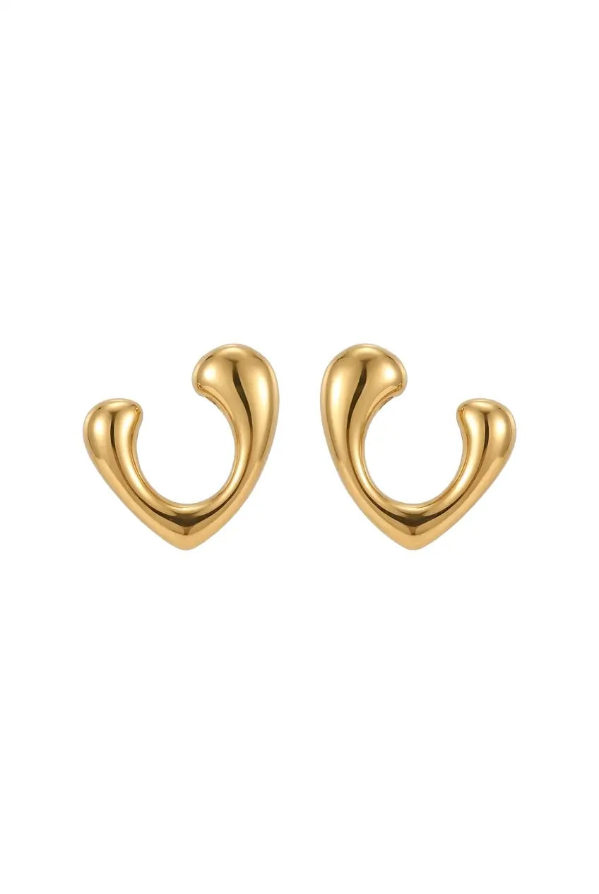 A pair of gold-toned, abstract U-shaped hoop earrings with a smooth, polished finish, displayed on a clean white background.